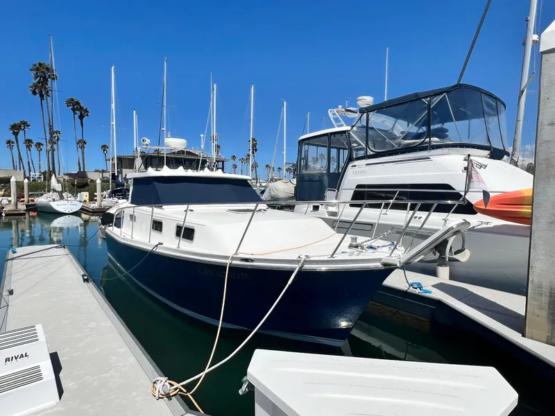 Slide: The Image of 2001 Norstar 301 boat docked in marina with clear blue sky. - 1