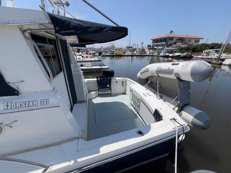 Slide: The Image of 2001 Norstar 301 boat docked with inflatable dinghy in marina. - 13