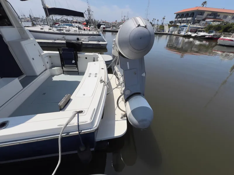 Slide: The Image of 2001 Norstar 301 boat docked in a marina with inflatable dinghy attached. - 14