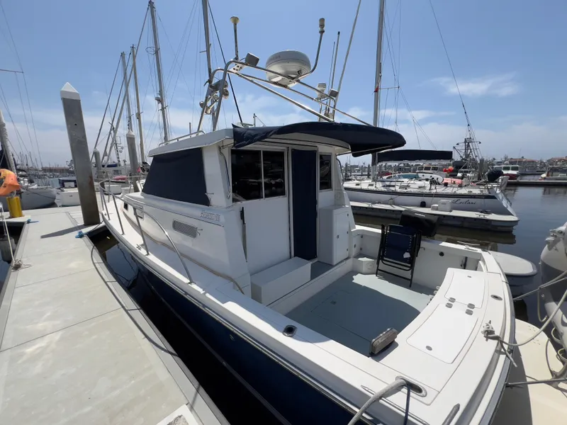 Slide: The Image of 2001 Norstar 301 boat docked at marina, featuring sleek design and spacious deck. - 15