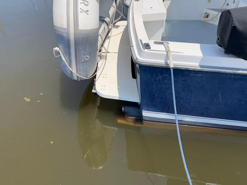 Slide: The Image of Norstar 301 boat, 2001 model, docked with an outboard motor in calm water. - 16