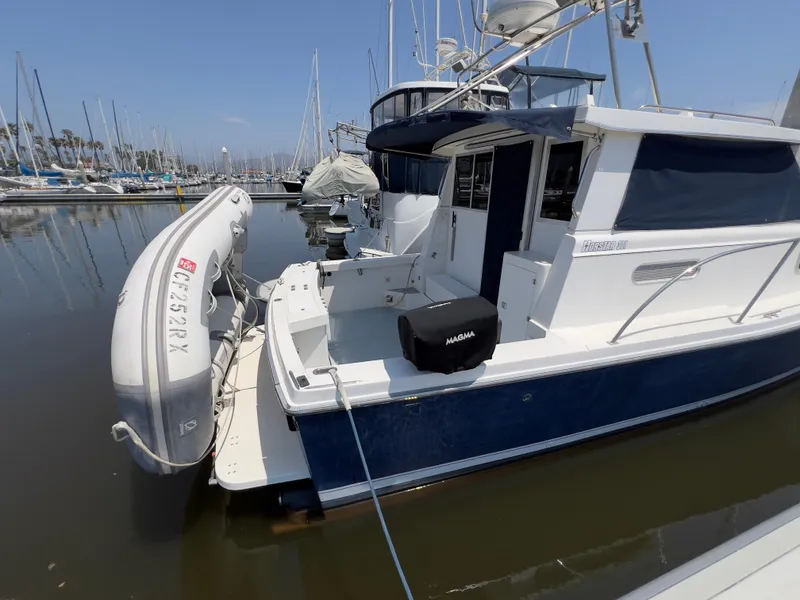 Slide: The Image of Norstar 301 boat from 2001 docked with inflatable dinghy attached. - 17