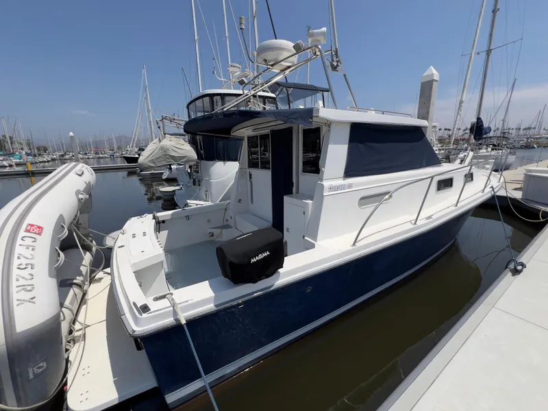 Slide: The Image of 2001 Norstar 301 boat docked in marina, featuring white and blue exterior. - 18