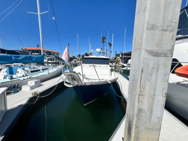 Slide: The Image of 2001 Norstar 301 boat docked in a marina under clear blue skies. - 2