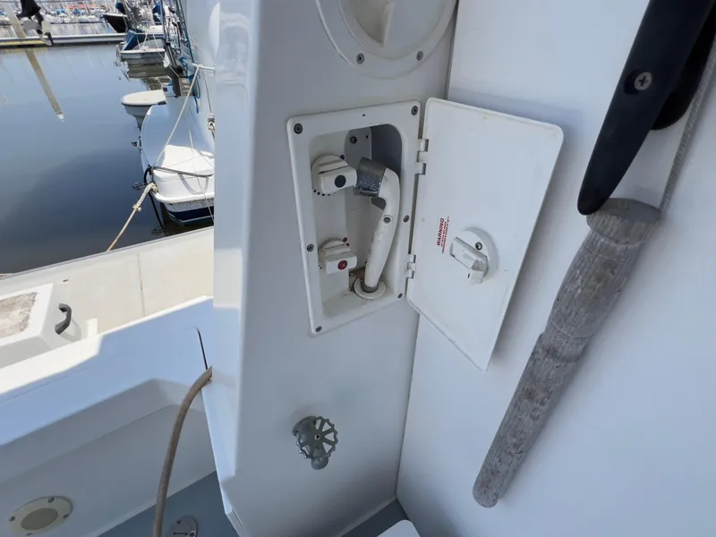 Slide: The Image of 2001 Norstar 301 boat deck with open utility compartment and marina view. - 22