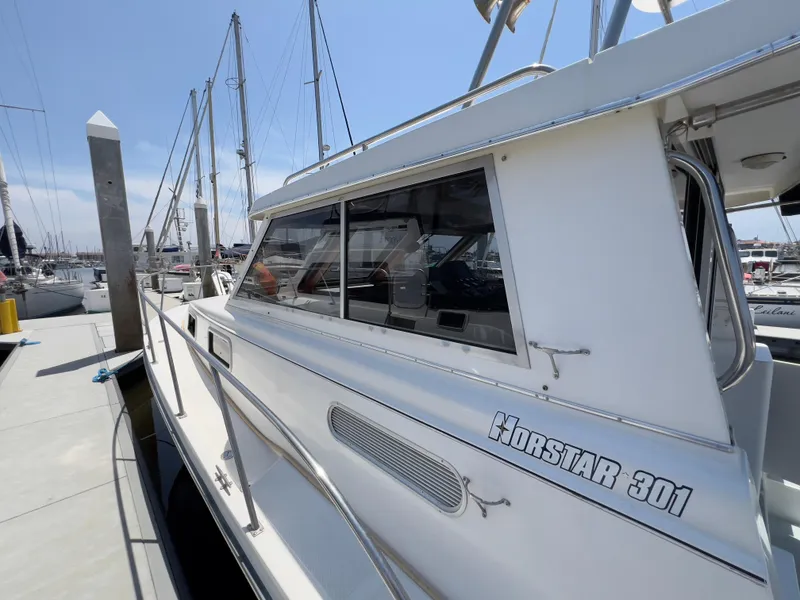 Slide: The Image of 2001 Norstar 301 boat docked at marina, side view with clear skies. - 25