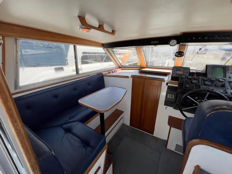 Slide: The Image of Interior of 2001 Norstar 301 boat with blue seating and navigation controls. - 28