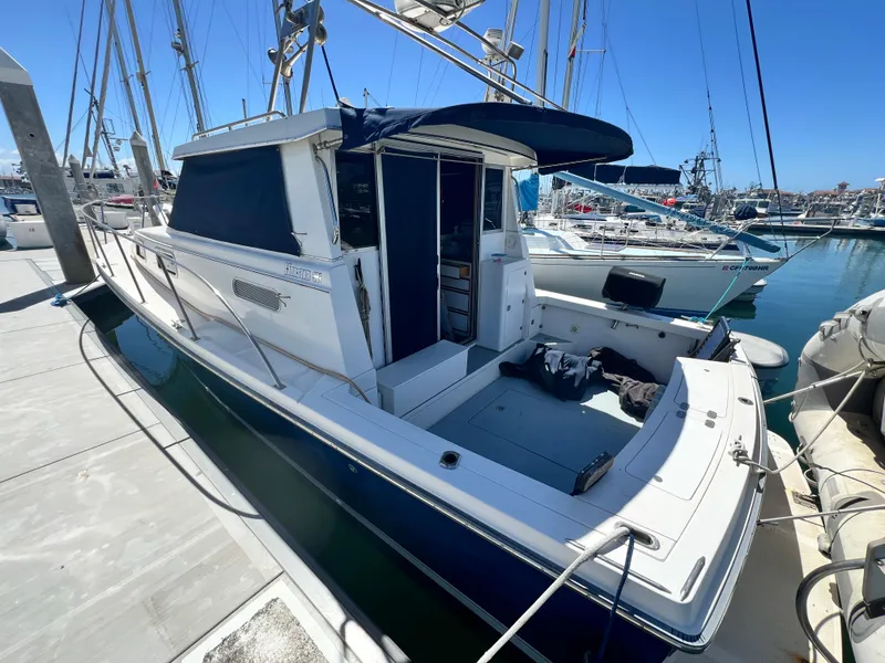 Slide: The Image of 2001 Norstar 301 boat docked at marina under clear blue sky. - 3