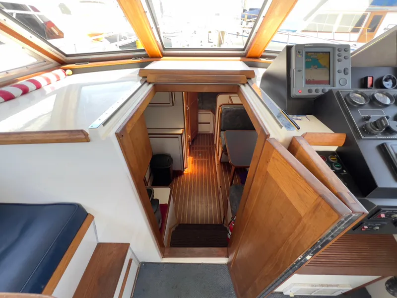 Slide: The Image of Interior view of a 2001 Norstar 301 boat, featuring wooden finishes and navigation equipment. - 32