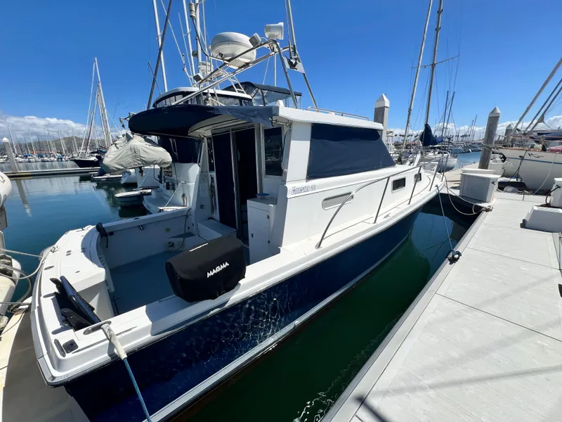 Slide: The Image of 2001 Norstar 301 boat docked at marina under clear blue sky. - 4