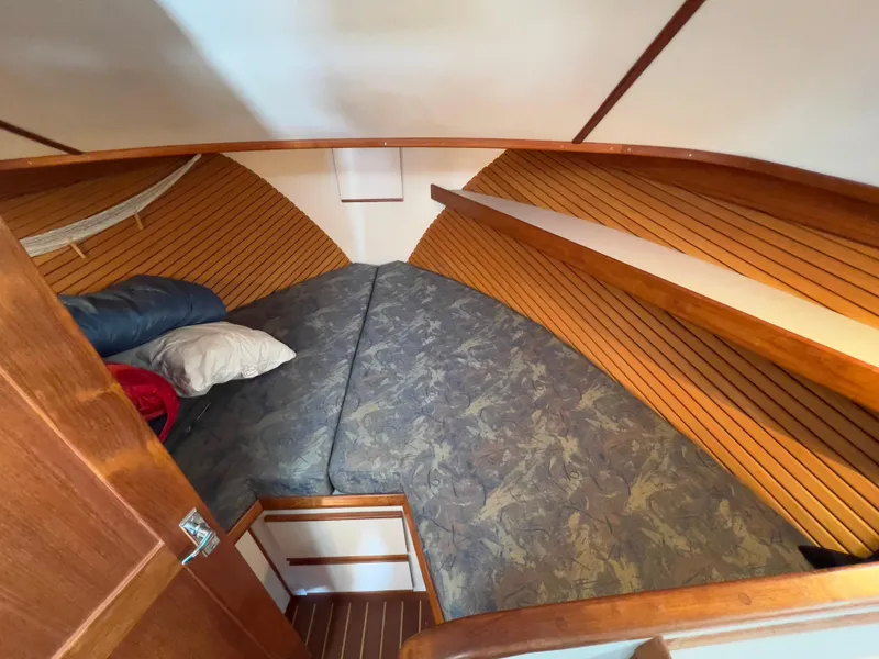 Slide: The Image of Cozy cabin interior of 2001 Norstar 301 boat with wooden paneling and bedding. - 40