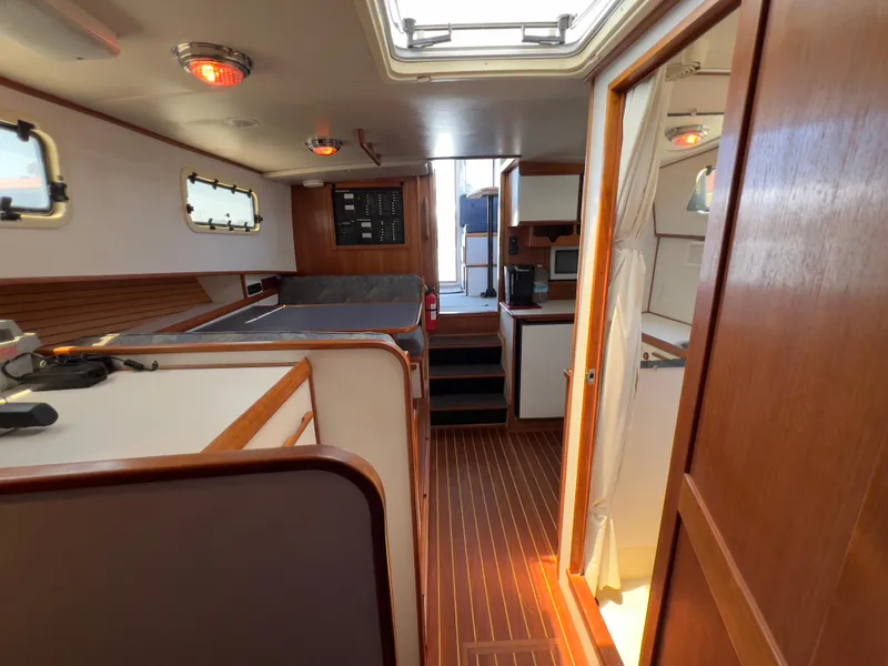Slide: The Image of Interior of 2001 Norstar 301 boat, featuring wood paneling and compact living space. - 44