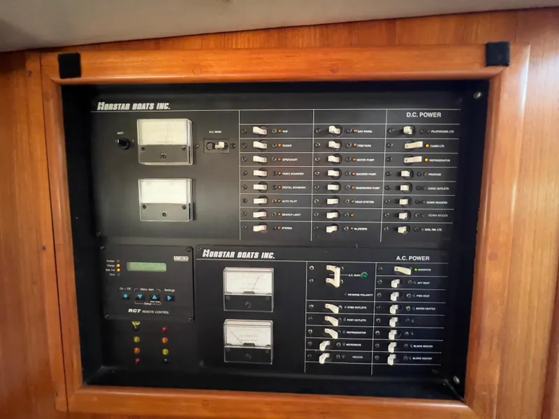 Slide: The Image of Electrical control panel on a 2001 Norstar 301 boat, featuring AC and DC power switches. - 49