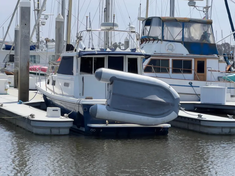 Slide: The Image of 2001 Norstar 301 boat docked at marina with inflatable dinghy on deck. - 9