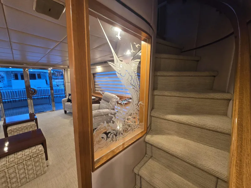 Slide: The Image of Interior of 1994 Hatteras 82 Convertible yacht with elegant staircase and etched glass artwork. - 11