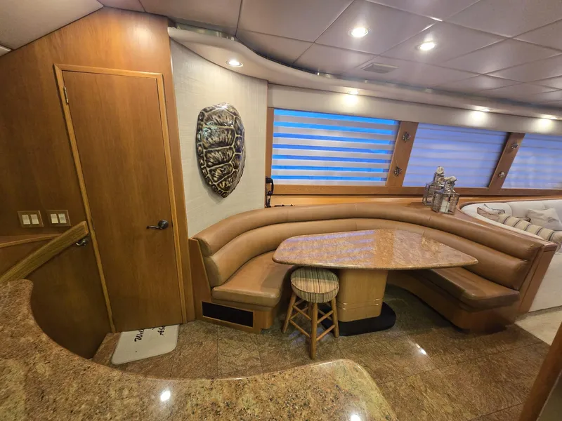 Slide: The Image of Luxurious interior of 1994 Hatteras 82 Convertible yacht with elegant dining area. - 13