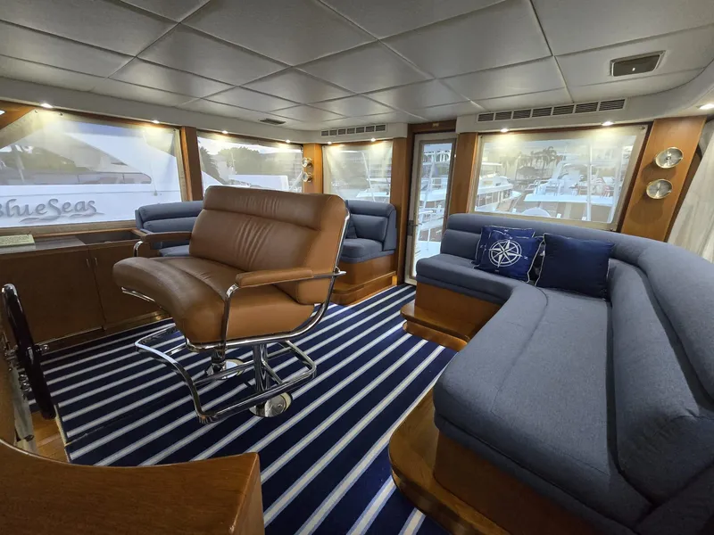 Slide: The Image of Luxurious interior of a 1994 Hatteras 82 Convertible yacht with plush seating and striped carpet. - 16