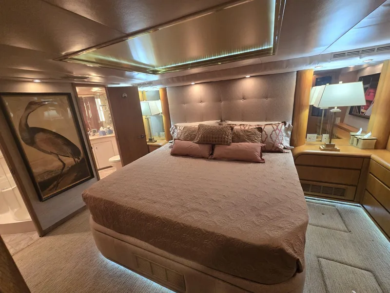 Slide: The Image of Luxurious bedroom interior of 1994 Hatteras 82 Convertible yacht with elegant decor and ambient lighting. - 19