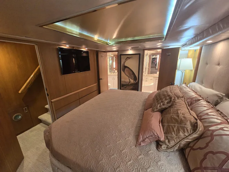 Slide: The Image of Luxurious bedroom interior of 1994 Hatteras 82 Convertible yacht with elegant bedding and ambient lighting. - 22