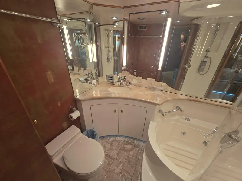 Slide: The Image of Luxurious bathroom in 1994 Hatteras 82 Convertible yacht with elegant fixtures and spacious design. - 23