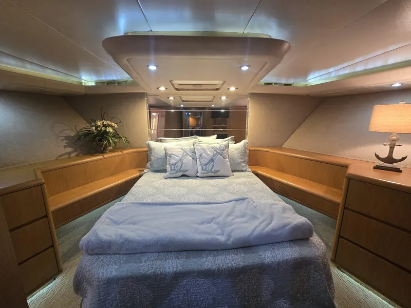 Slide: The Image of Luxurious bedroom interior of 1994 Hatteras 82 Convertible yacht with cozy bedding and ambient lighting. - 25
