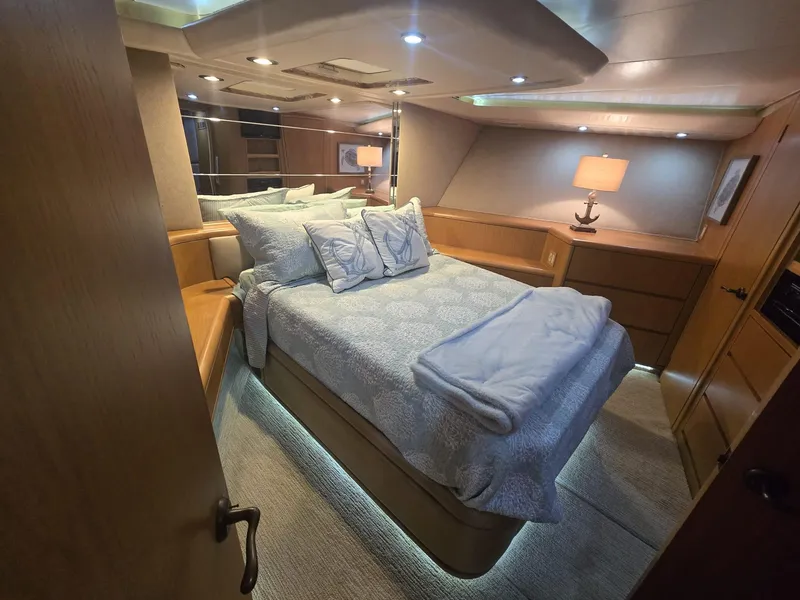 Slide: The Image of Luxurious bedroom interior of 1994 Hatteras 82 Convertible yacht with cozy lighting. - 26