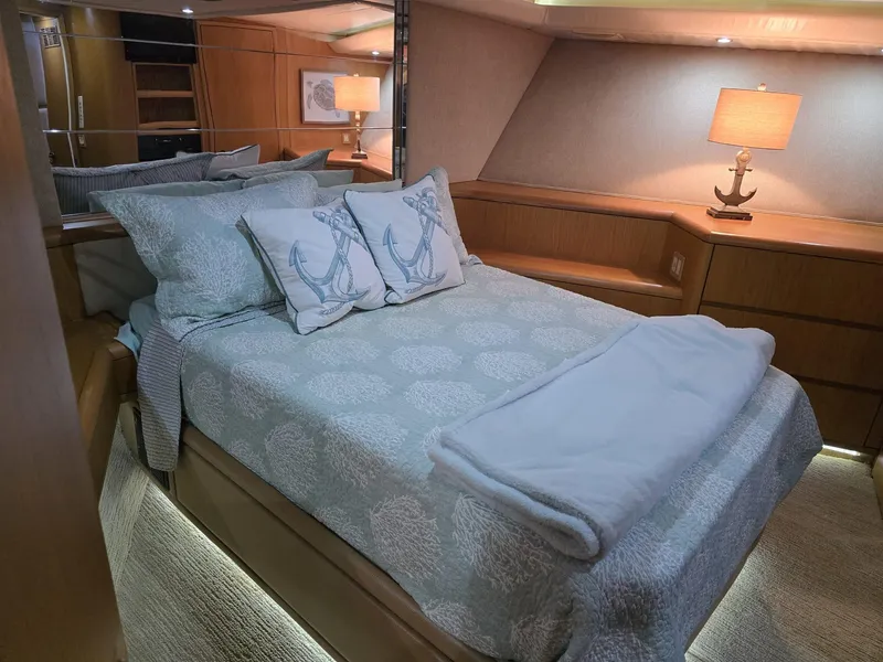 Slide: The Image of Luxurious bedroom interior of 1994 Hatteras 82 Convertible yacht with nautical-themed decor. - 27