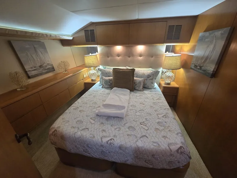 Slide: The Image of Luxurious bedroom interior of 1994 Hatteras 82 Convertible yacht with elegant decor and cozy bedding. - 28