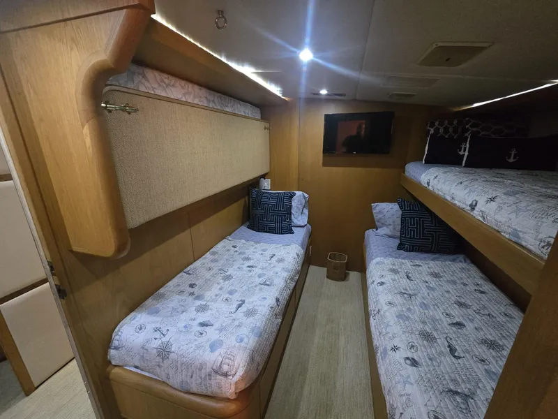 Slide: The Image of Cozy cabin interior of 1994 Hatteras 82 Convertible yacht with bunk beds and nautical decor. - 32