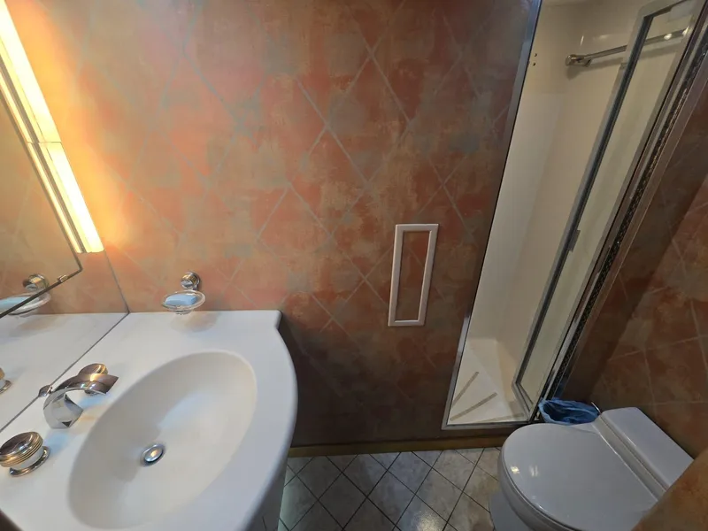 Slide: The Image of Bathroom interior of 1994 Hatteras 82 Convertible yacht, featuring sink, toilet, and shower. - 33