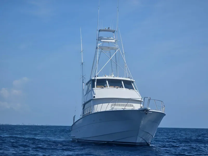 Slide: The Image of Hatteras 82 Convertible yacht, 1994 model, cruising on open sea under clear blue sky. - 37