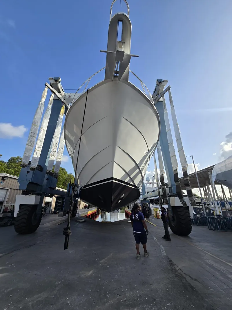 Slide: The Image of 1994 Hatteras 82 Convertible yacht in dry dock, viewed from the front. - 41