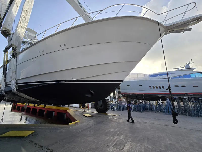 Slide: The Image of 1994 Hatteras 82 Convertible yacht in dry dock, showcasing sleek design and craftsmanship. - 42