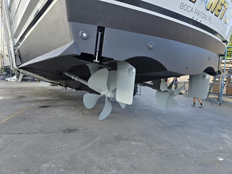 Slide: The Image of 1994 Hatteras 82 Convertible yacht with visible propellers, docked for maintenance. - 44