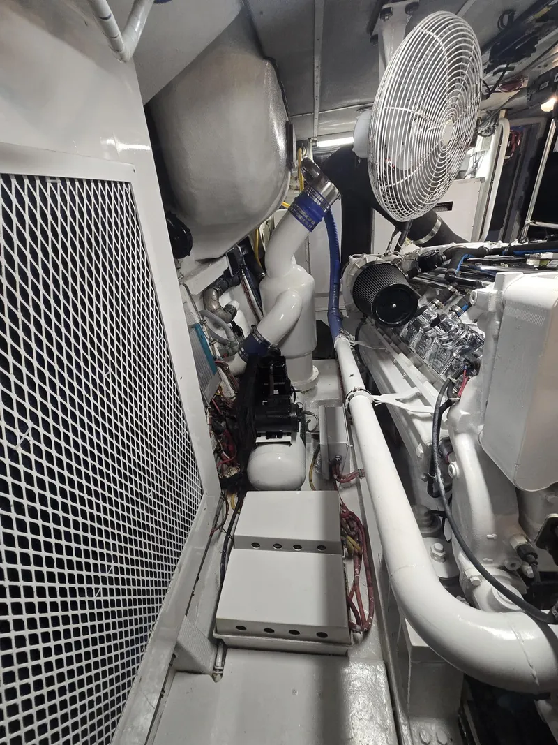 Slide: The Image of Engine room of 1994 Hatteras 82 Convertible yacht, featuring machinery and ventilation. - 53