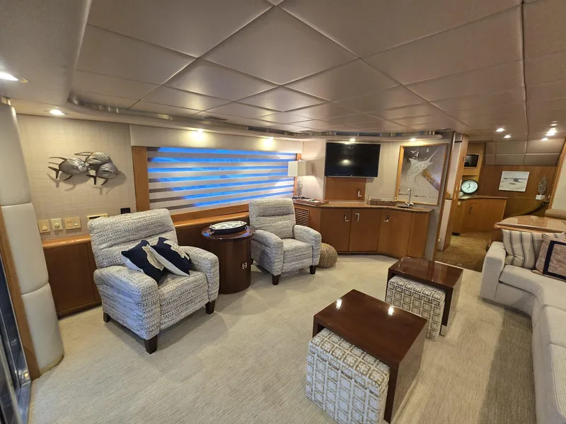 Slide: The Image of Luxurious interior of 1994 Hatteras 82 Convertible yacht with plush seating and modern decor. - 6