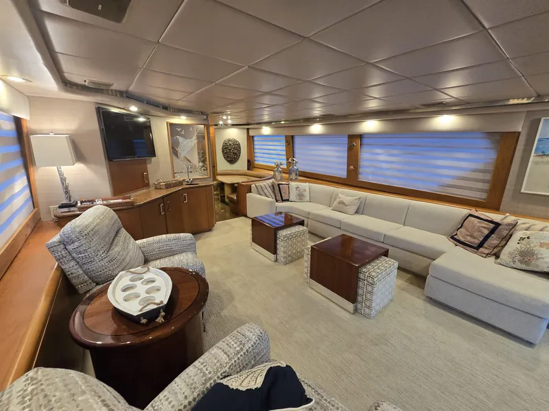 Slide: The Image of Luxurious interior of a 1994 Hatteras 82 Convertible yacht with elegant seating and decor. - 7