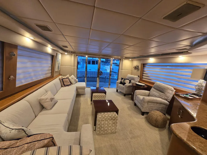 Slide: The Image of Luxurious interior of a 1994 Hatteras 82 Convertible yacht with elegant seating and decor. - 9