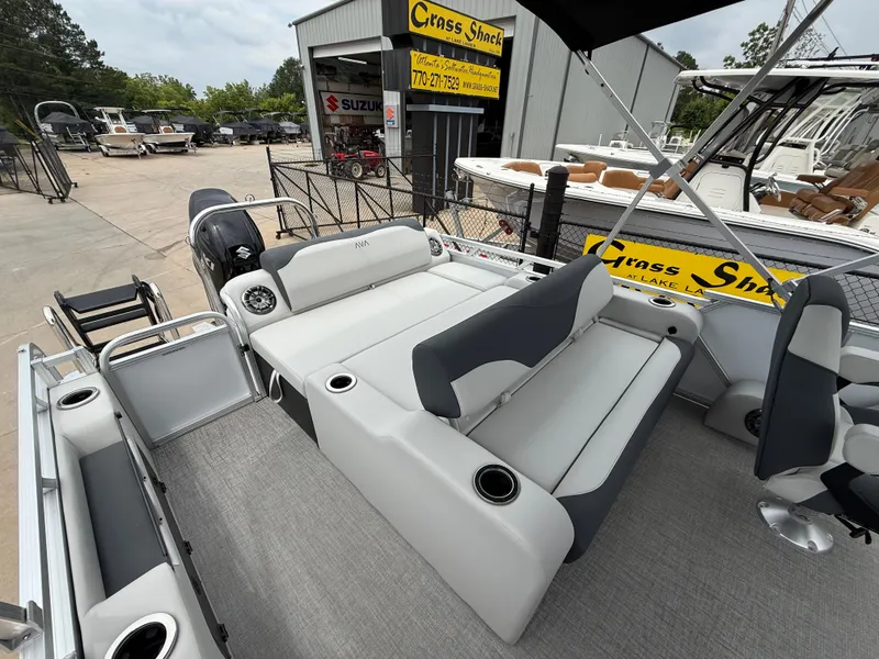 Slide: The Image of 2025 Avalon LSZ Versatile Rear Lounger pontoon boat at dealership, featuring spacious seating. - 14