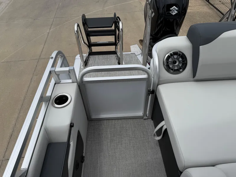 Slide: The Image of 2025 Avalon LSZ Versatile Rear Lounger boat interior with seating, speaker, and ladder. - 19