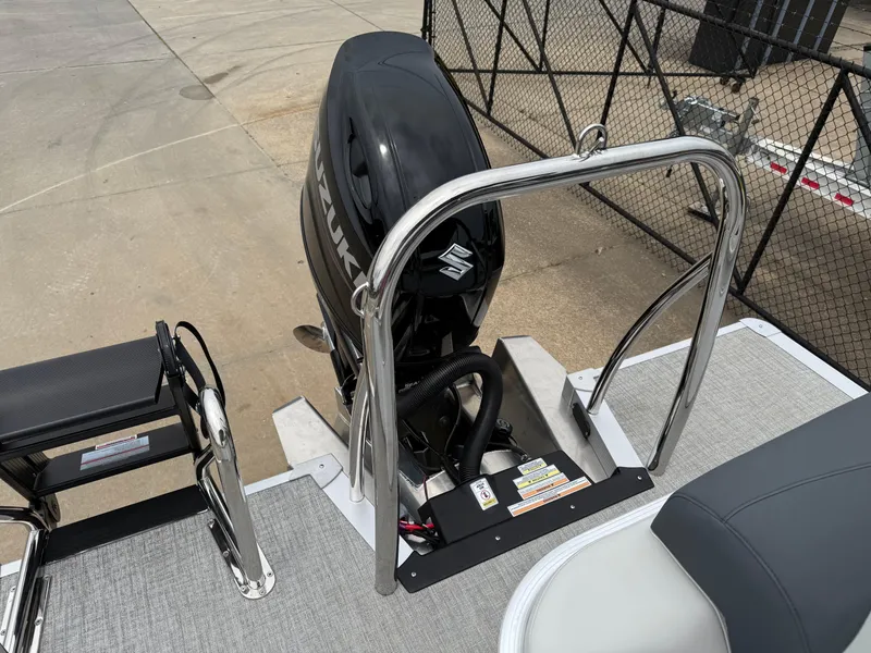 Slide: The Image of 2025 Avalon LSZ Versatile Rear Lounger with Suzuki outboard motor, docked on concrete. - 20