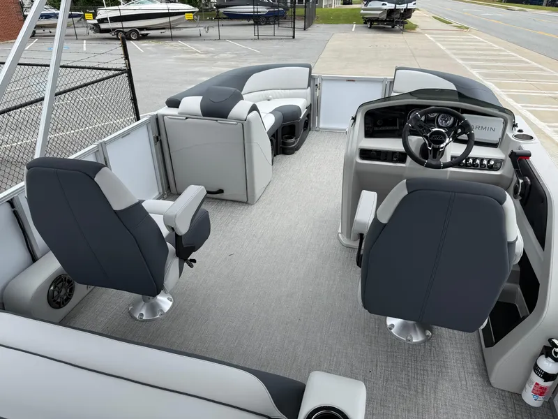 Slide: The Image of 2025 Avalon LSZ Versatile Rear Lounger boat interior with modern seating and steering console. - 23