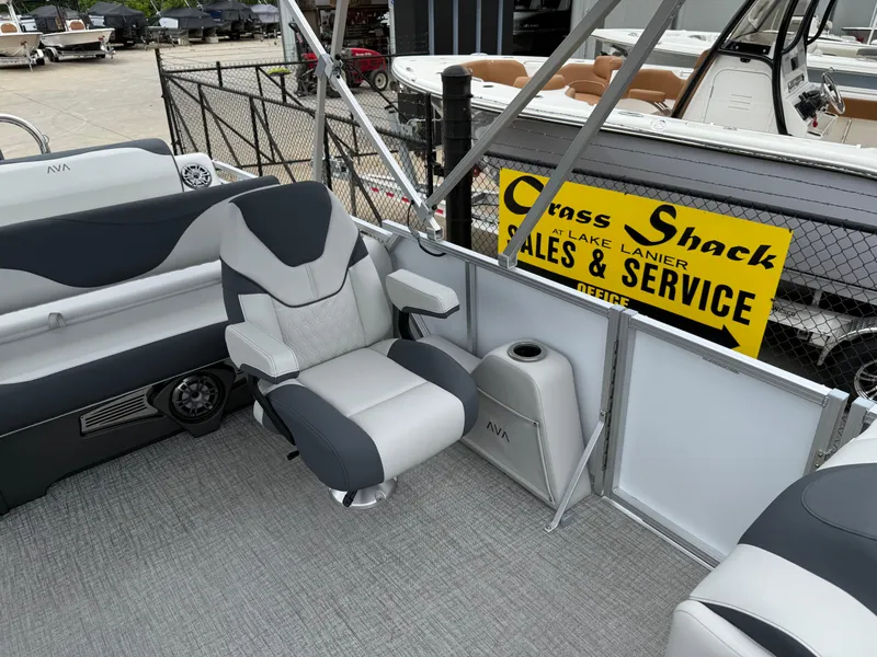 Slide: The Image of 2025 Avalon LSZ Versatile Rear Lounger boat interior with plush seating and cup holder. - 34