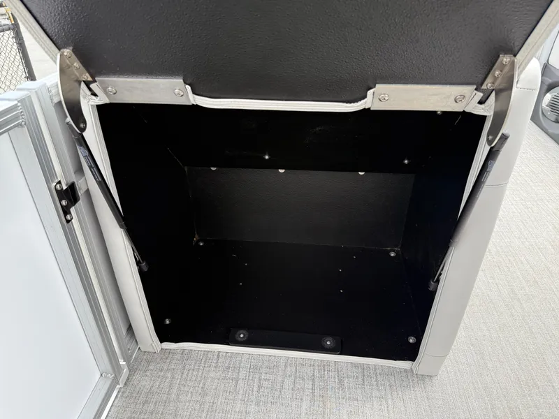 Slide: The Image of 2025 Avalon LSZ Versatile Rear Lounger storage compartment, open and empty, with metal hinges. - 35