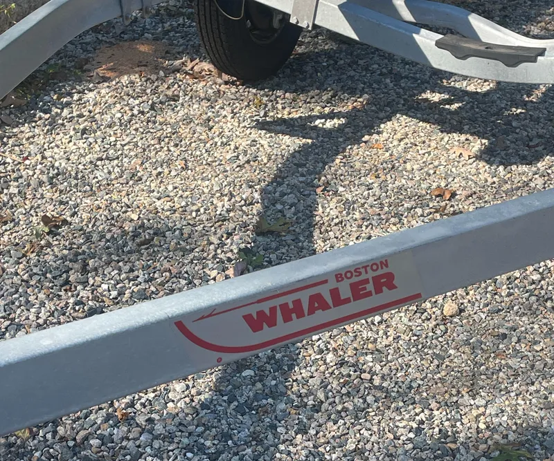 Slide: The Image of Trailer for 2021 Boston Whaler 210 Montauk on gravel surface. - 17
