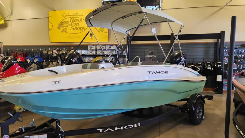 Slide: The Image of 2025 Tahoe T16 boat displayed indoors on a trailer. - 2