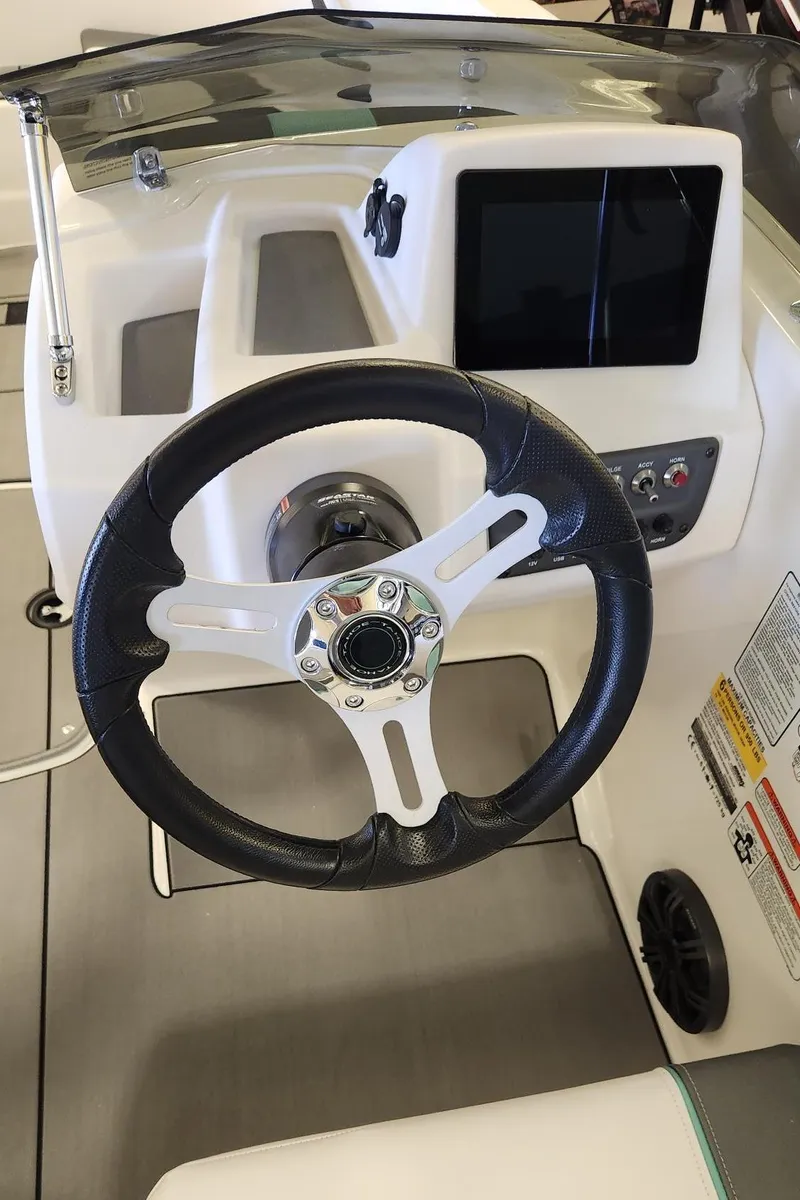 Slide: The Image of Steering wheel and dashboard of 2025 Tahoe T16 boat, featuring modern controls and display. - 3