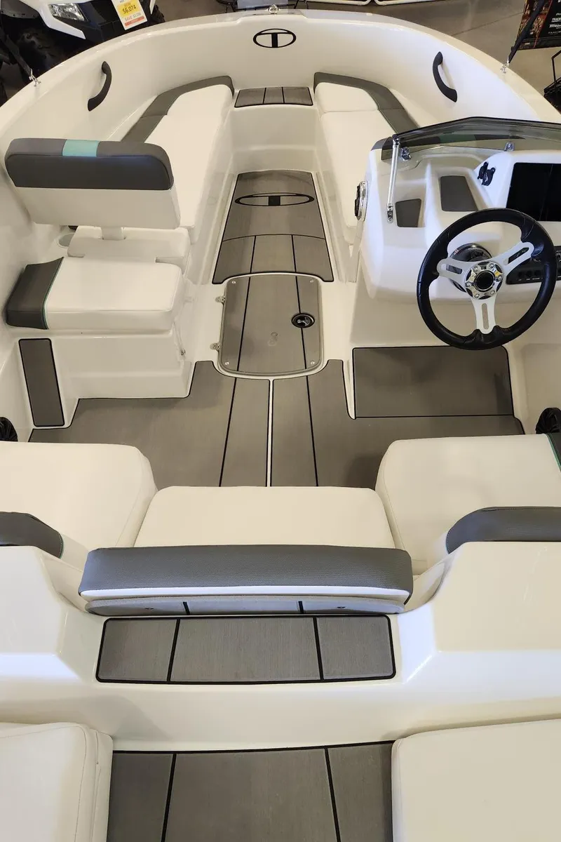 Slide: The Image of 2025 Tahoe T16 boat interior with modern seating and steering wheel design. - 6