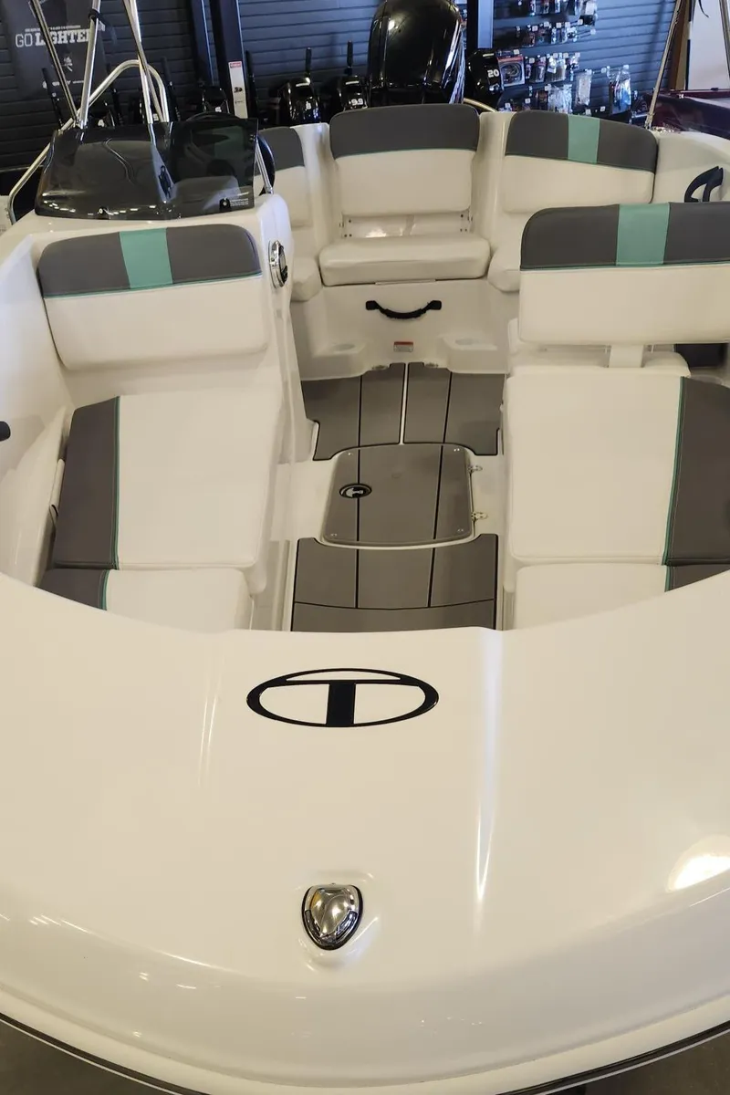 Slide: The Image of 2025 Tahoe T16 boat interior with white and gray seating, modern design. - 7