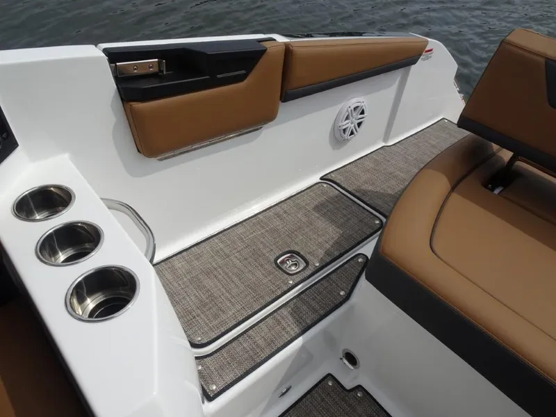 Slide: The Image of Interior of 2025 Cobalt R31 boat with brown seating, cup holders, and speaker. - 10